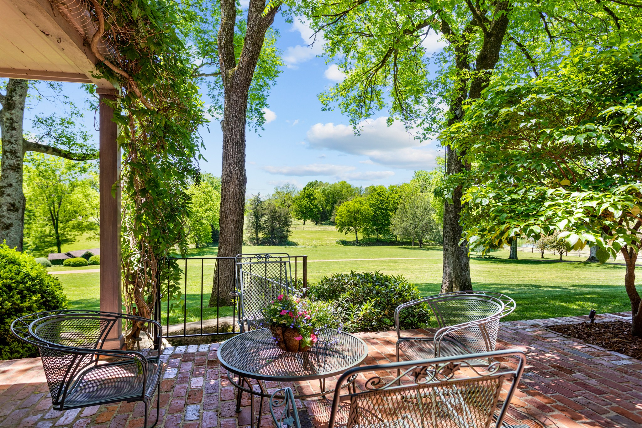 370 Vaughn Road Nashville, TN 37221 - Photo 23 of 27 a view of a patio with table and chairs potted plants with large tree