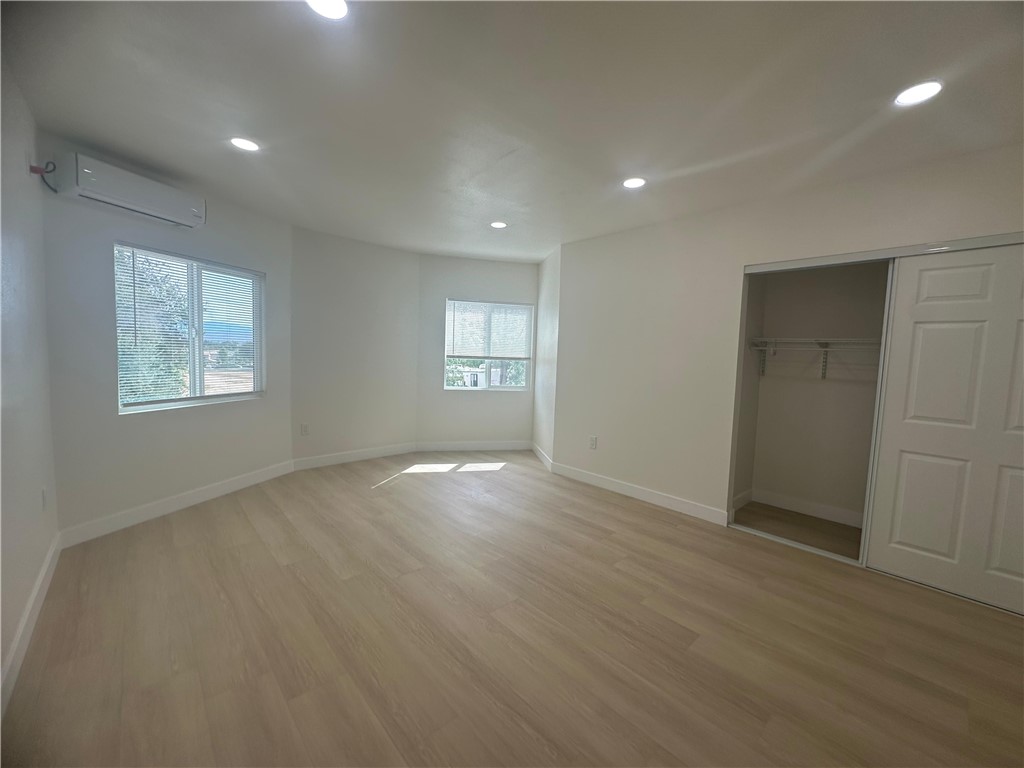 5778 La Sierra Avenue Riverside, CA 92505 - Photo 6 of 8 an empty room with wooden floor and windows