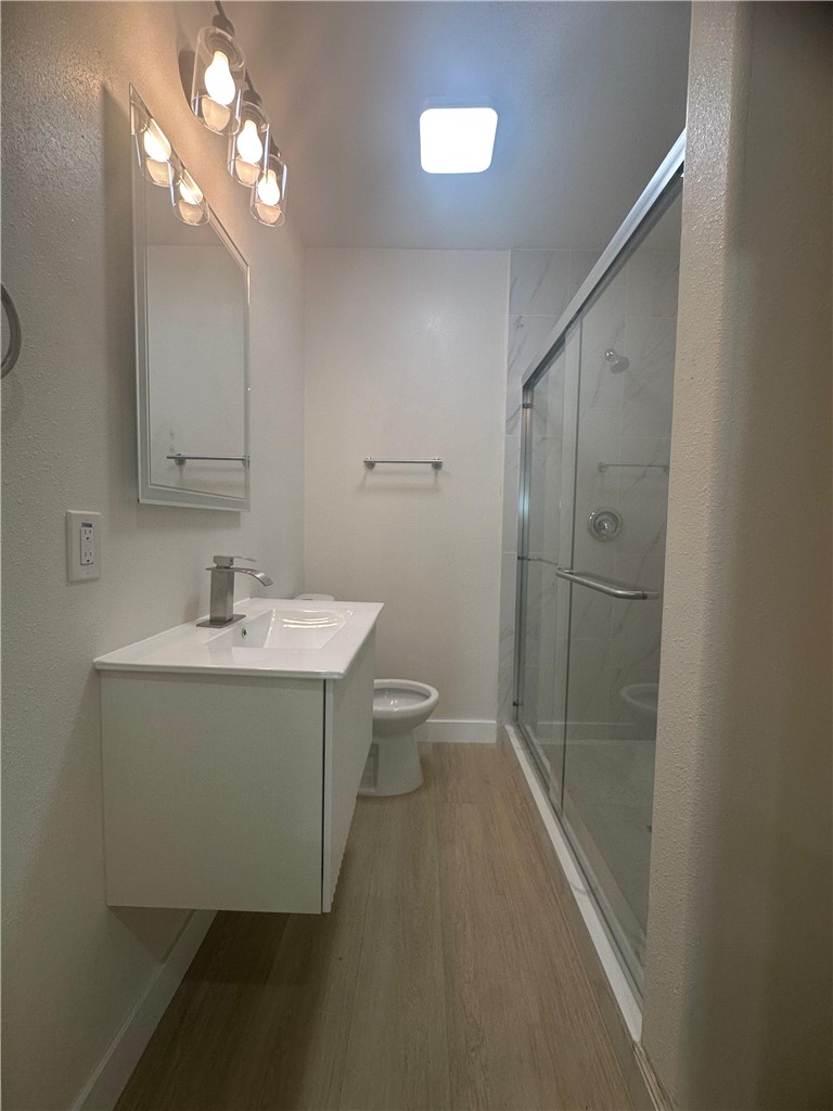 5778 La Sierra Avenue Riverside, CA 92505 - Photo 7 of 8 a bathroom with a sink mirror vanity and toilet