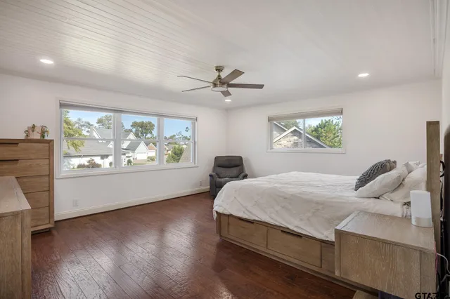 a bedroom with a large bed and a window
