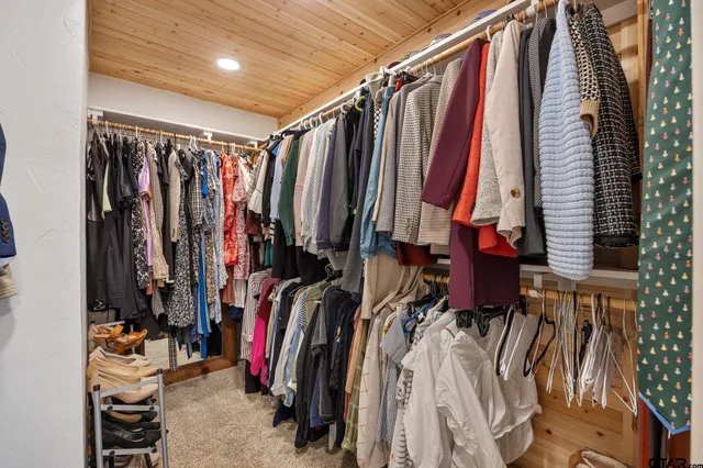 a view of walk in closet with clothes