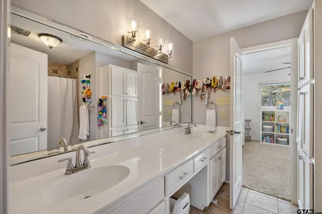 a bathroom with a sink double vanity and a mirror