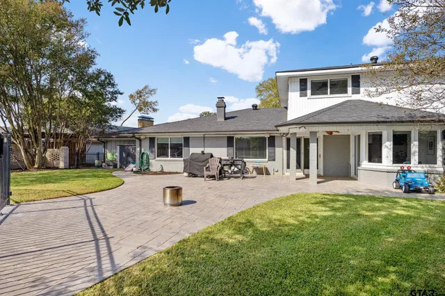 a view of a house with swimming pool and a yard