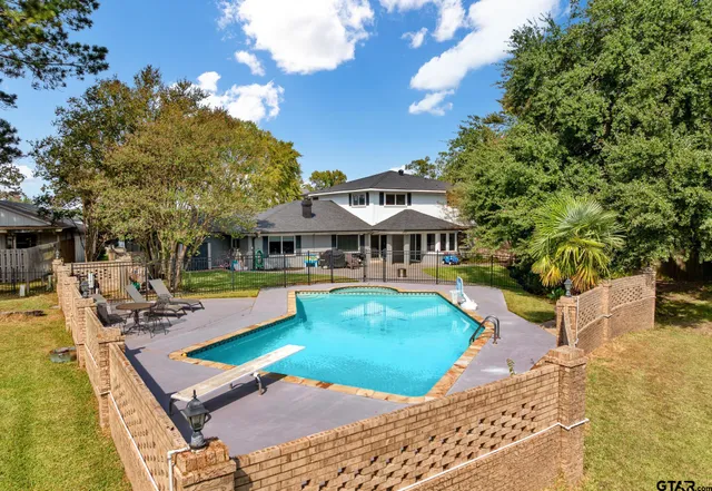 a view of a house with swimming pool and sitting area
