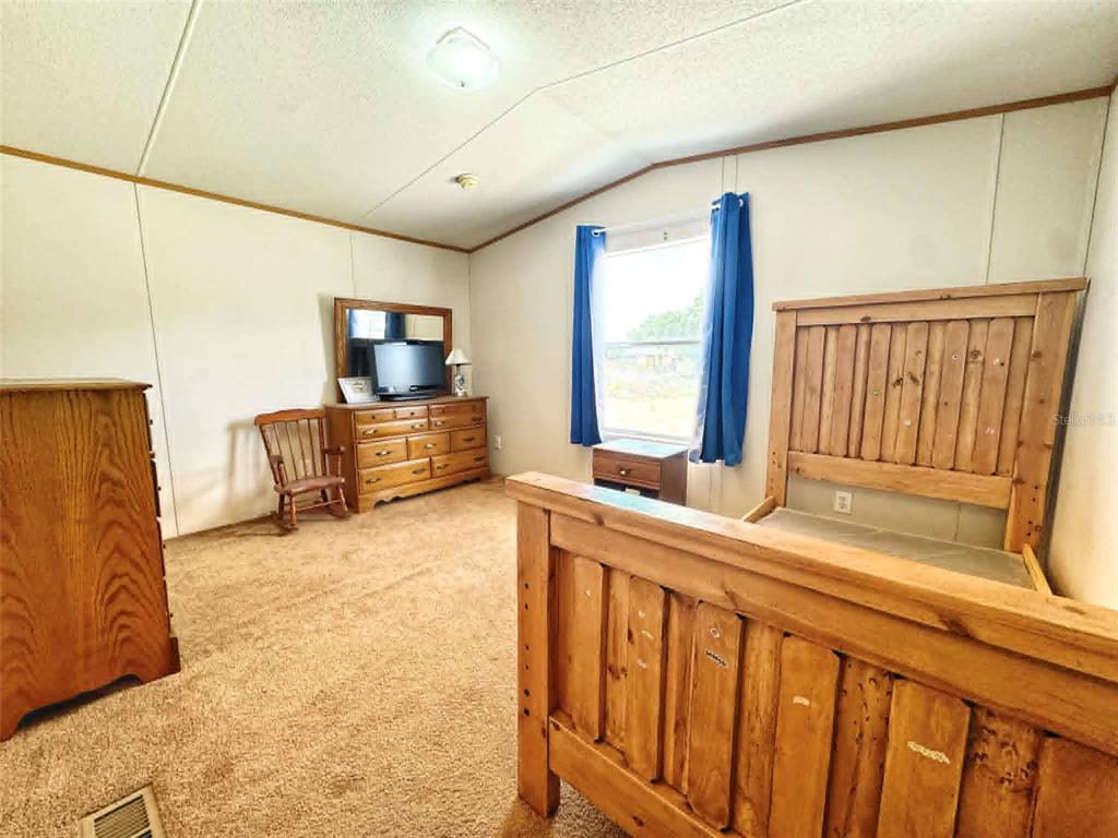 612 Morgan Road Winter Haven, FL 33880 - Photo 13 of 38 a bedroom with furniture and a window