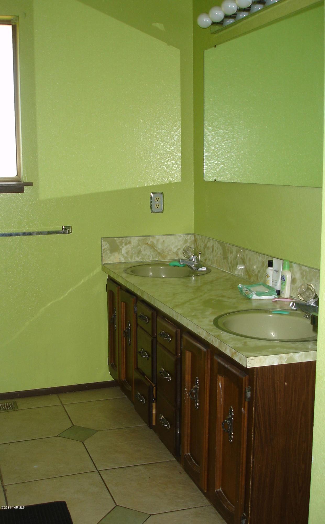 4650 Progressive Road Wapato, WA 98951 - Photo 8 of 12 a bathroom with a granite countertop sink and a mirror