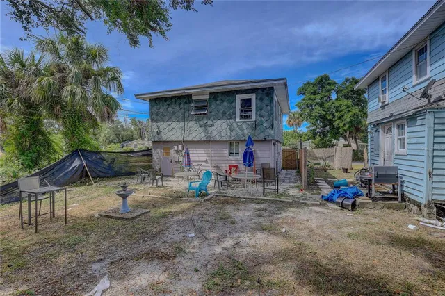 a view of house with chairs and fire pit