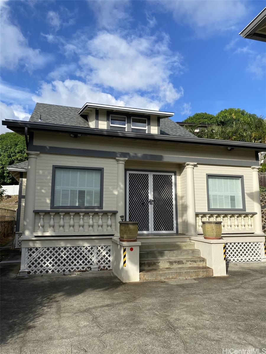 a front view of a house with a garden