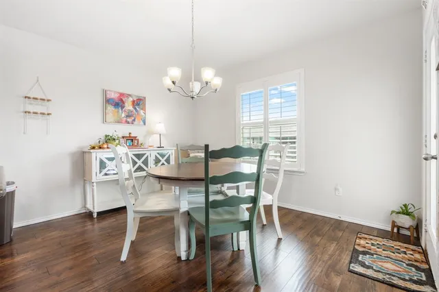 a view of a dining room with furniture wooden floor and chandelier