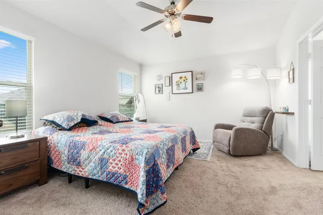 a bedroom with a bed couch and window