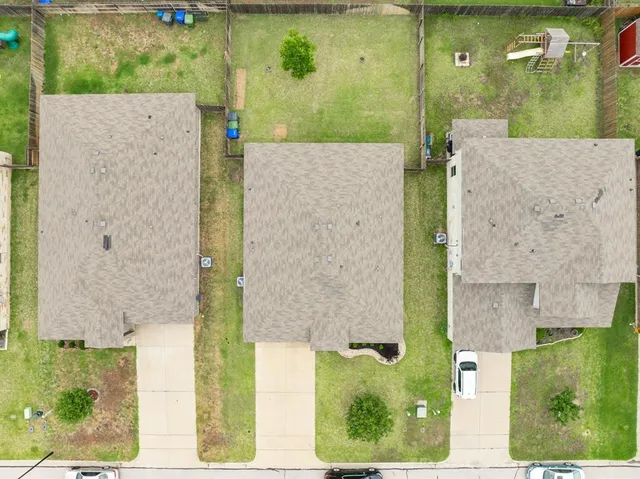 an aerial view of a house with a yard