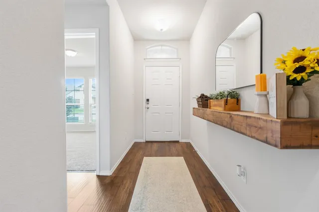 a hallway with sliding door and wooden floor