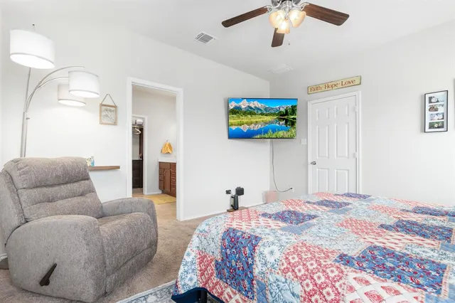 a bedroom with a bed and ceiling fan