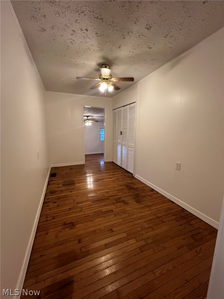 1105 Dutch Ridge Road Guysville, OH 45735 - Photo 11 of 33 Room featuring wood-finish flooring, white walls, and a ceiling fan with light fixture