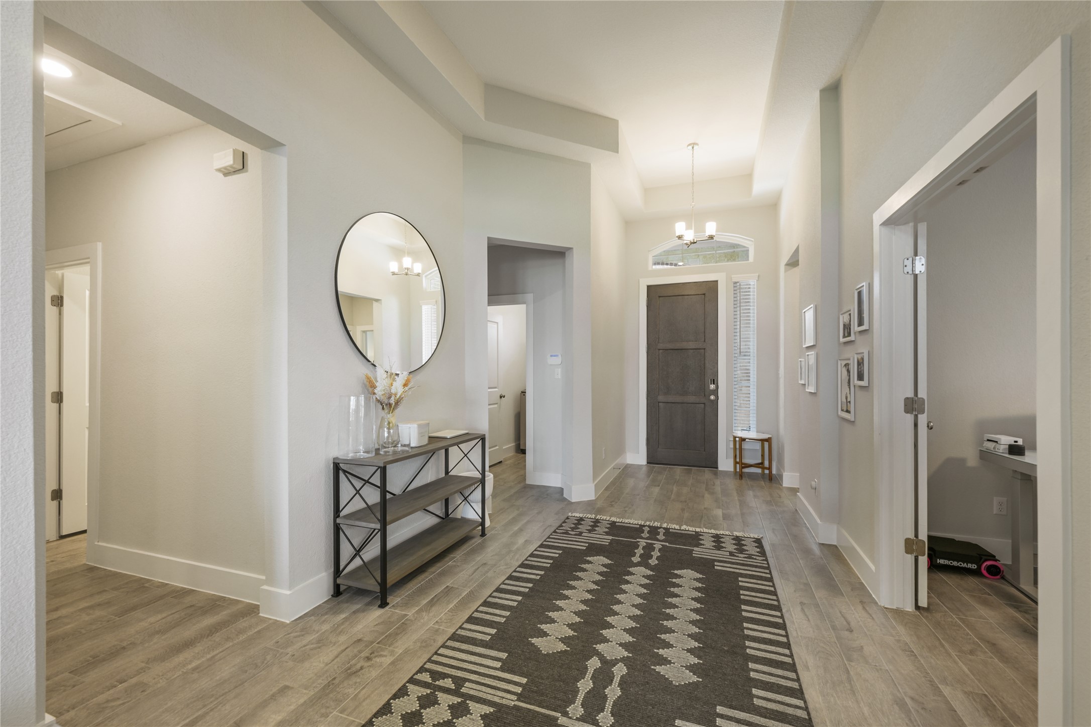 238 Wild Pecan Loop Buda, TX 78610 - Photo 4 of 31 High ceilings and wood-look tile flooring create an inviting first impression in this entry.