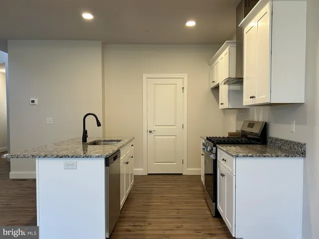 a kitchen with a sink stove and cabinets