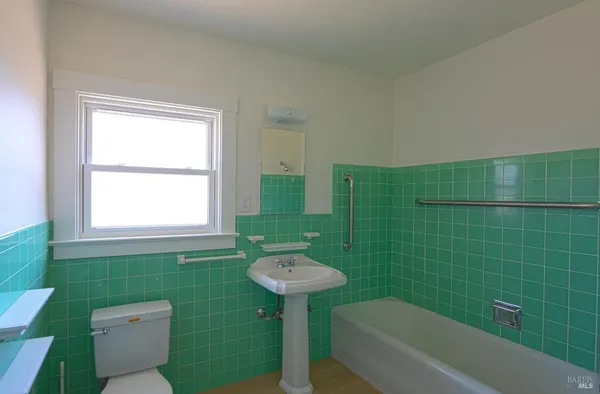 a bathroom with a sink a toilet and bathtub