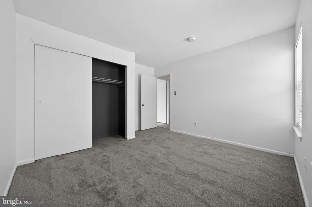a view of an empty room with closet