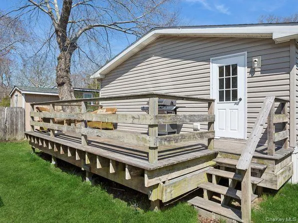 a view of a roof deck with couches and a yard