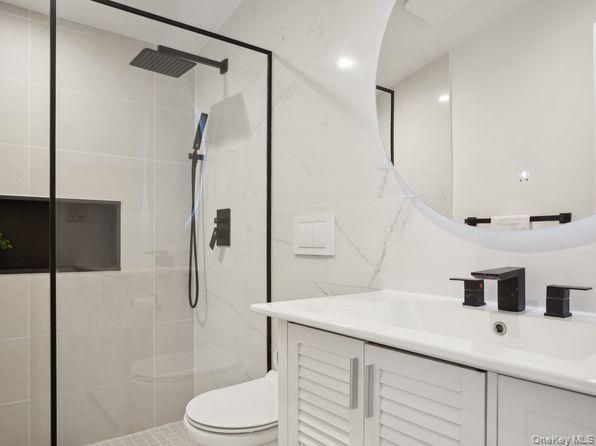 337 Three Mile Harbor Road, Unit 10 East Hampton, NY 11937 - Photo 5 of 16 a bathroom with a sink a toilet and shower