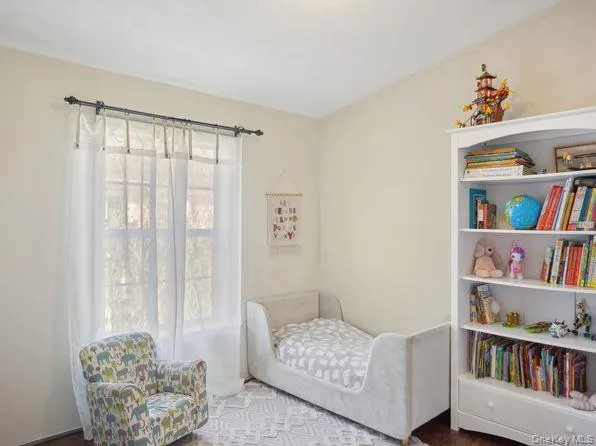 a living room with furniture and a book shelf