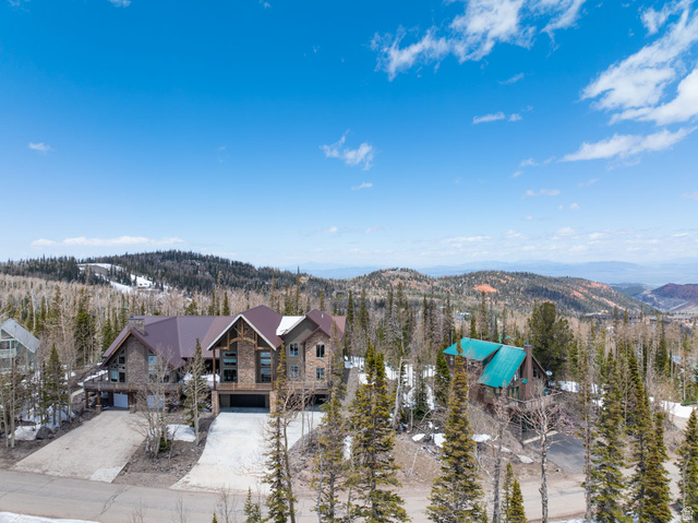 382 Ridgeview Street, Unit 8 & 9 Brian Head, UT 84719 - Photo 6 of 52 Expansive mountain property featuring a stone and wood-clad exterior with a dark brown roof