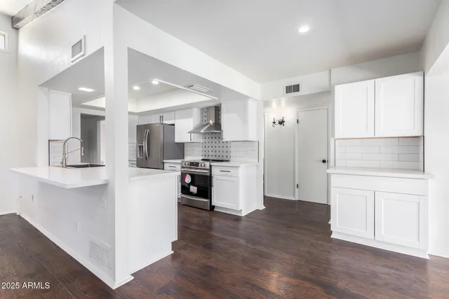 a kitchen with stainless steel appliances granite countertop a stove and a sink