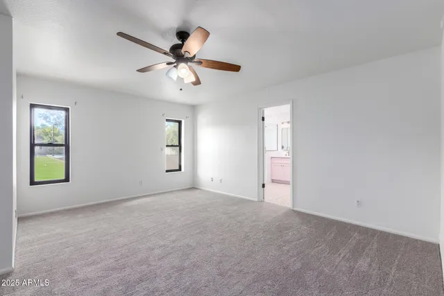 a spacious bathroom with a double vanity sink and mirror