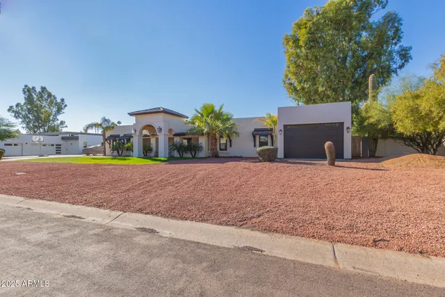 a view of an empty room with wooden floor fireplace and a window