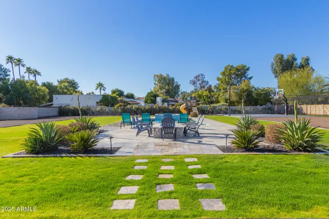 a view of a house with a yard and sitting area