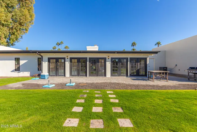 a view of a swimming pool with a lounge chair and a fire pit