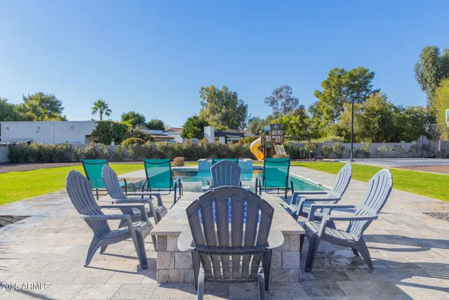 a view of a house with pool and sitting area