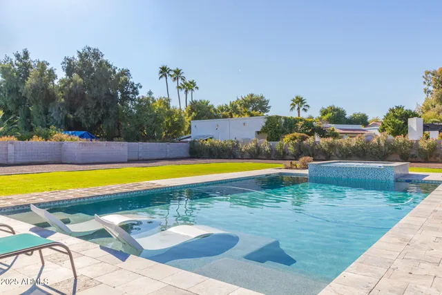 a view of a swimming pool with an outdoor space and seating area