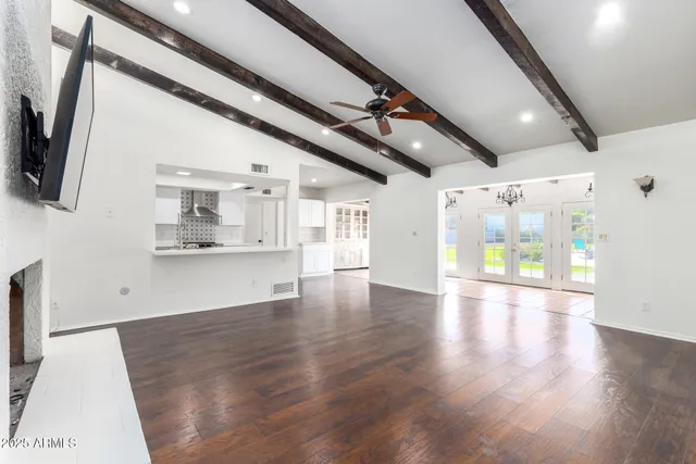 a view of an empty room with a fireplace and a window
