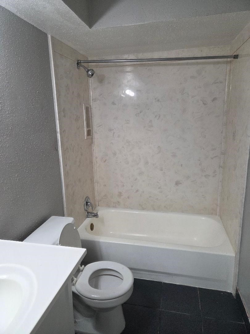 2000 Bahama Drive, Unit 30 Seabrook, TX 77586 - Photo 14 of 14 a bathroom with a sink a toilet and a bathtub