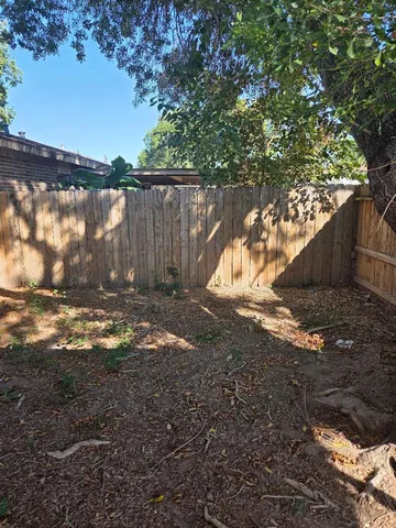 a view of a yard with large trees