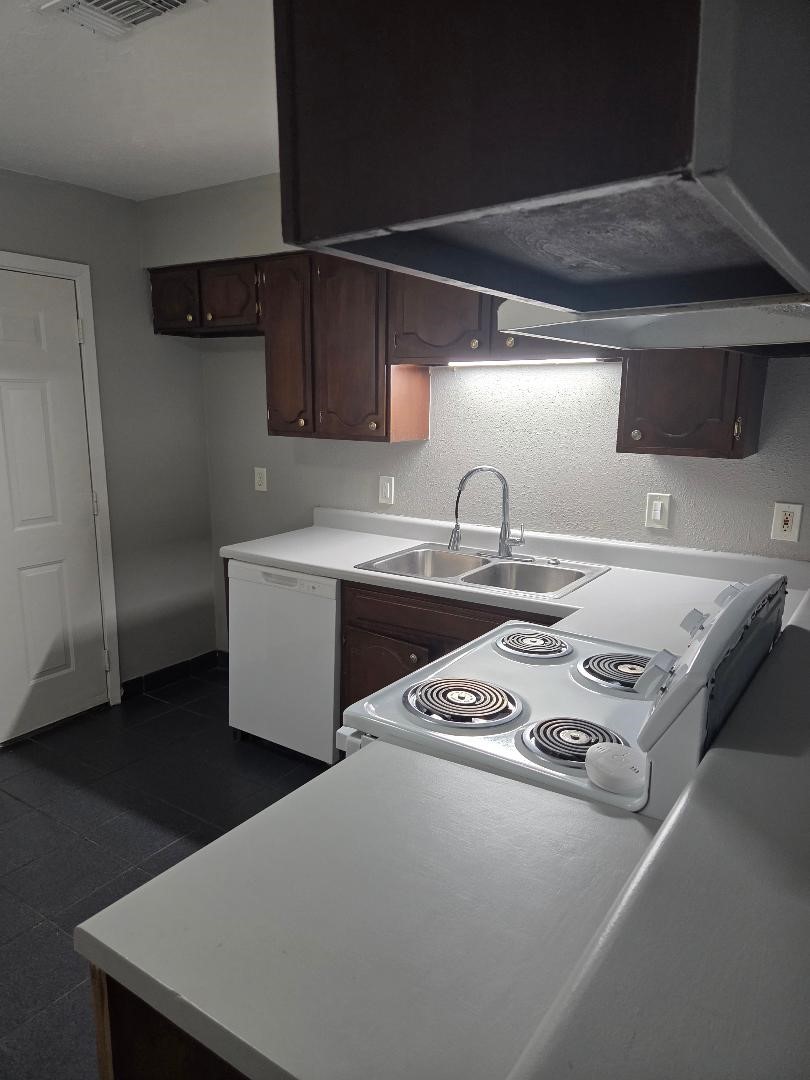 2000 Bahama Drive, Unit 30 Seabrook, TX 77586 - Photo 5 of 14 a kitchen with stainless steel appliances a sink a stove and a refrigerator