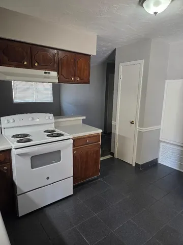 a kitchen with a stove and a refrigerator