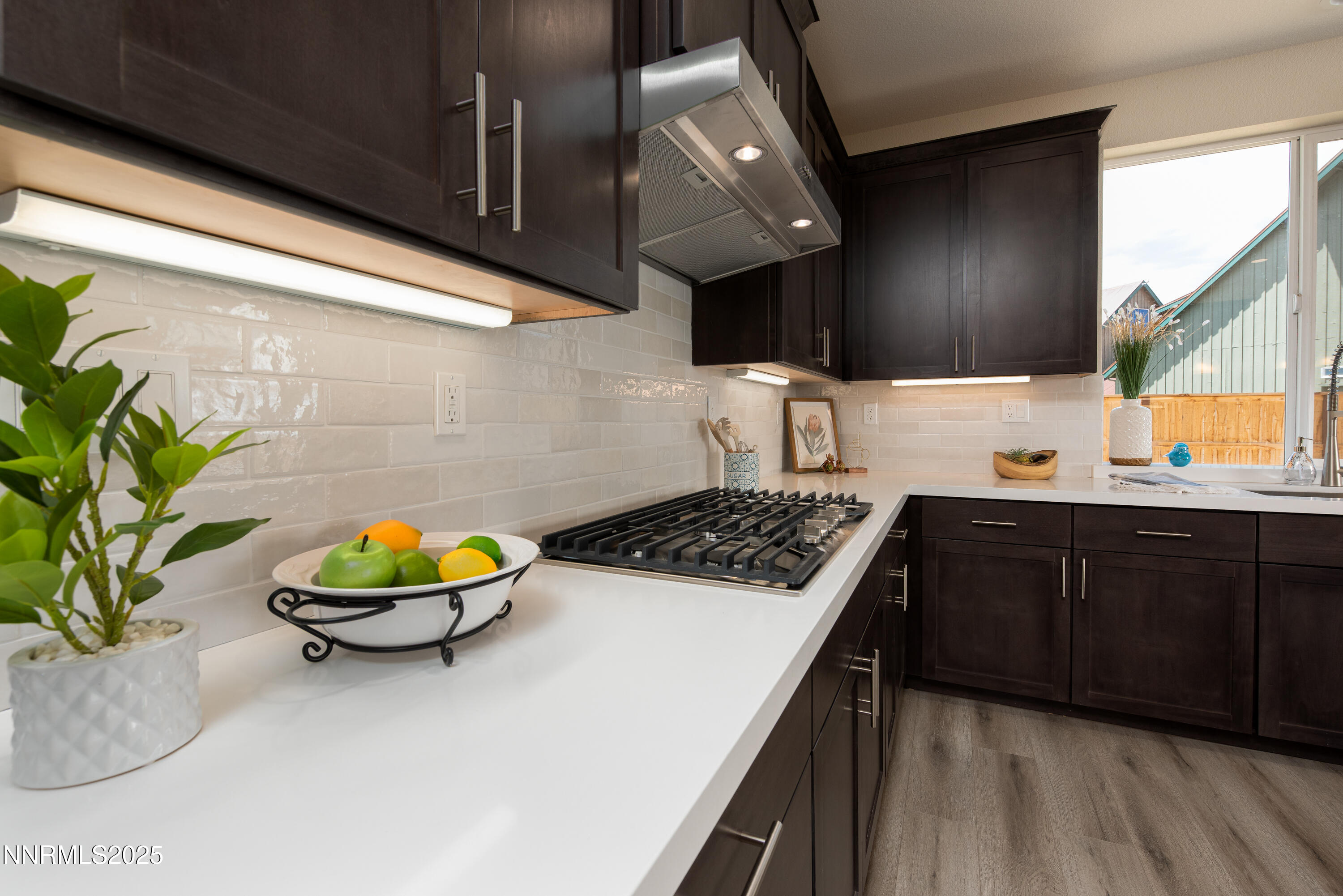692 Sage Grouse Loop Gardnerville, NV 89460 - Photo 15 of 36 a kitchen with a sink a stove and cabinets
