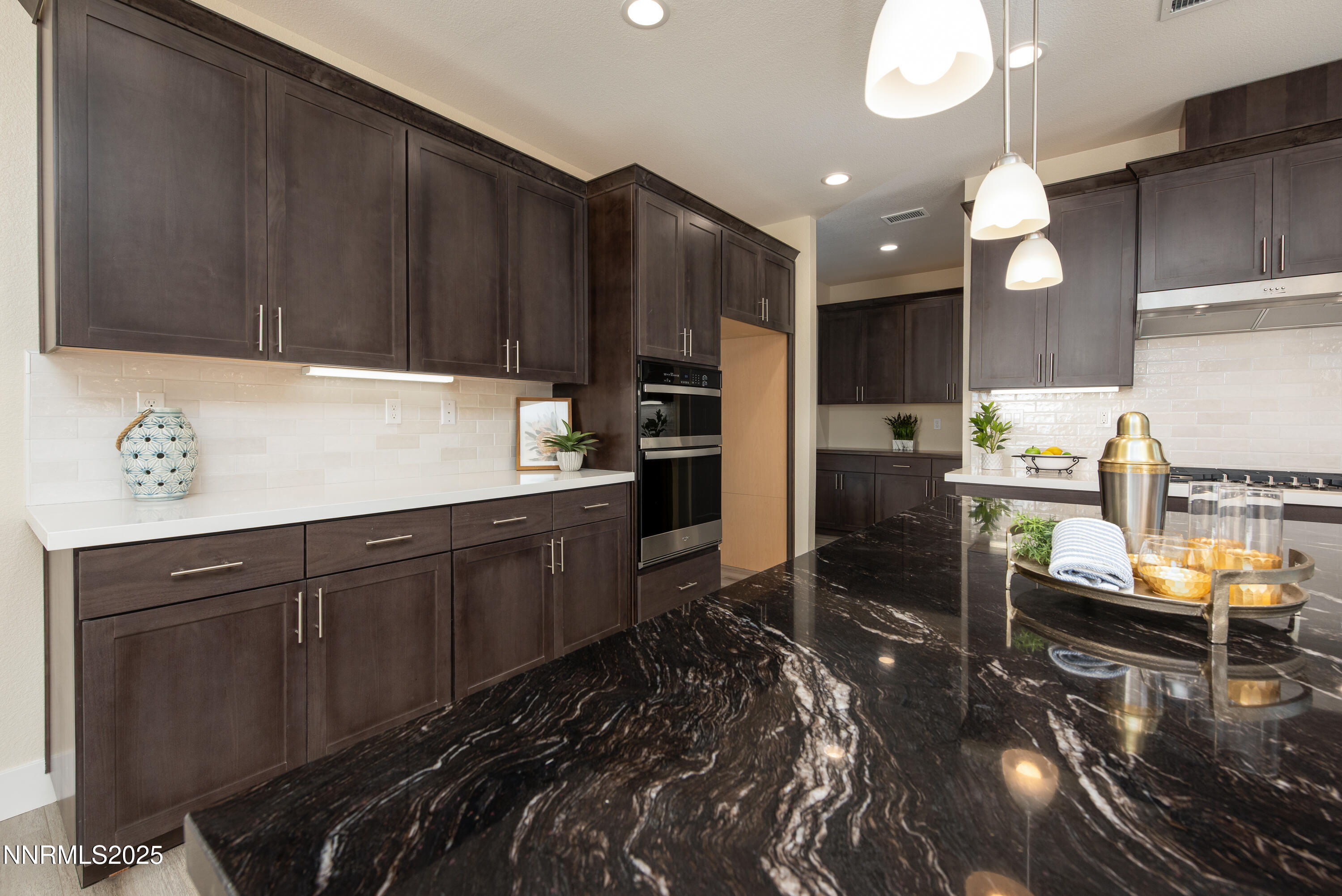 692 Sage Grouse Loop Gardnerville, NV 89460 - Photo 16 of 36 a kitchen with kitchen island granite countertop a stove refrigerator and cabinets
