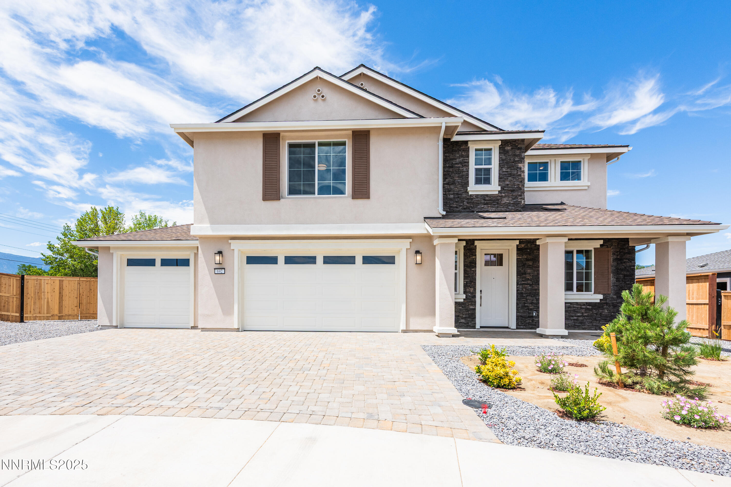 692 Sage Grouse Loop Gardnerville, NV 89460 - Photo 5 of 36 a front view of a house with a yard and potted plants