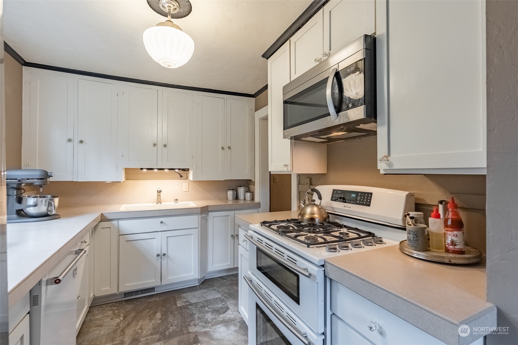 2212 Broadway Bellingham, WA 98225 - Photo 13 of 40 a kitchen with stainless steel appliances a sink stove and cabinets