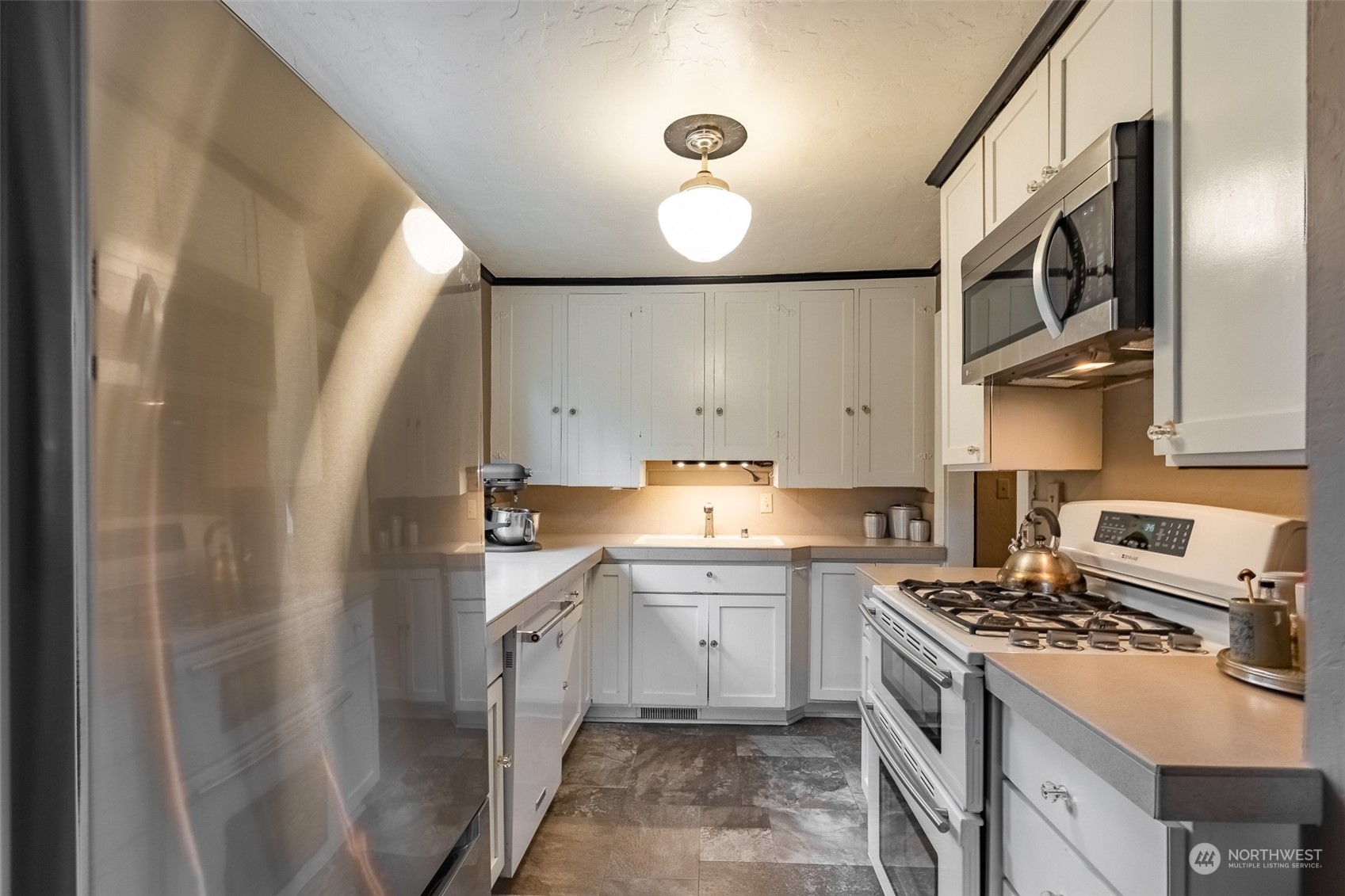 2212 Broadway Bellingham, WA 98225 - Photo 16 of 40 a kitchen with cabinets and stainless steel appliances