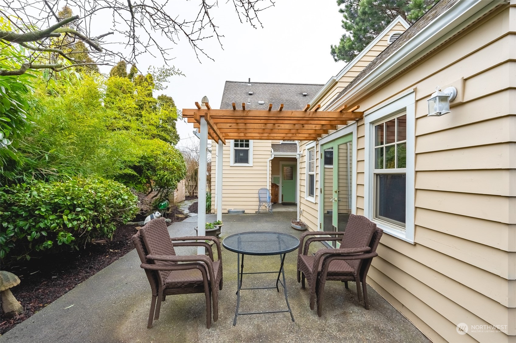 2212 Broadway Bellingham, WA 98225 - Photo 32 of 40 a view of a patio with table and chairs and potted plants with wooden floor and seating space
