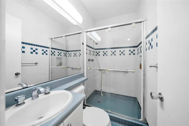 a bathroom with a sink toilet and shower