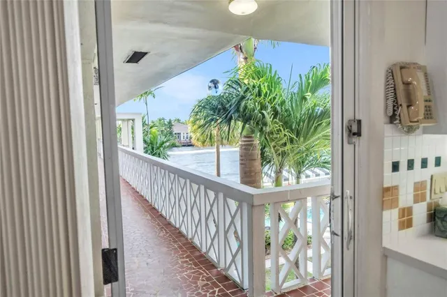 a view of staircase with railing and flowers
