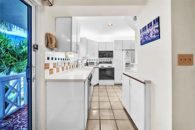 a kitchen with stainless steel appliances a refrigerator and a stove top oven