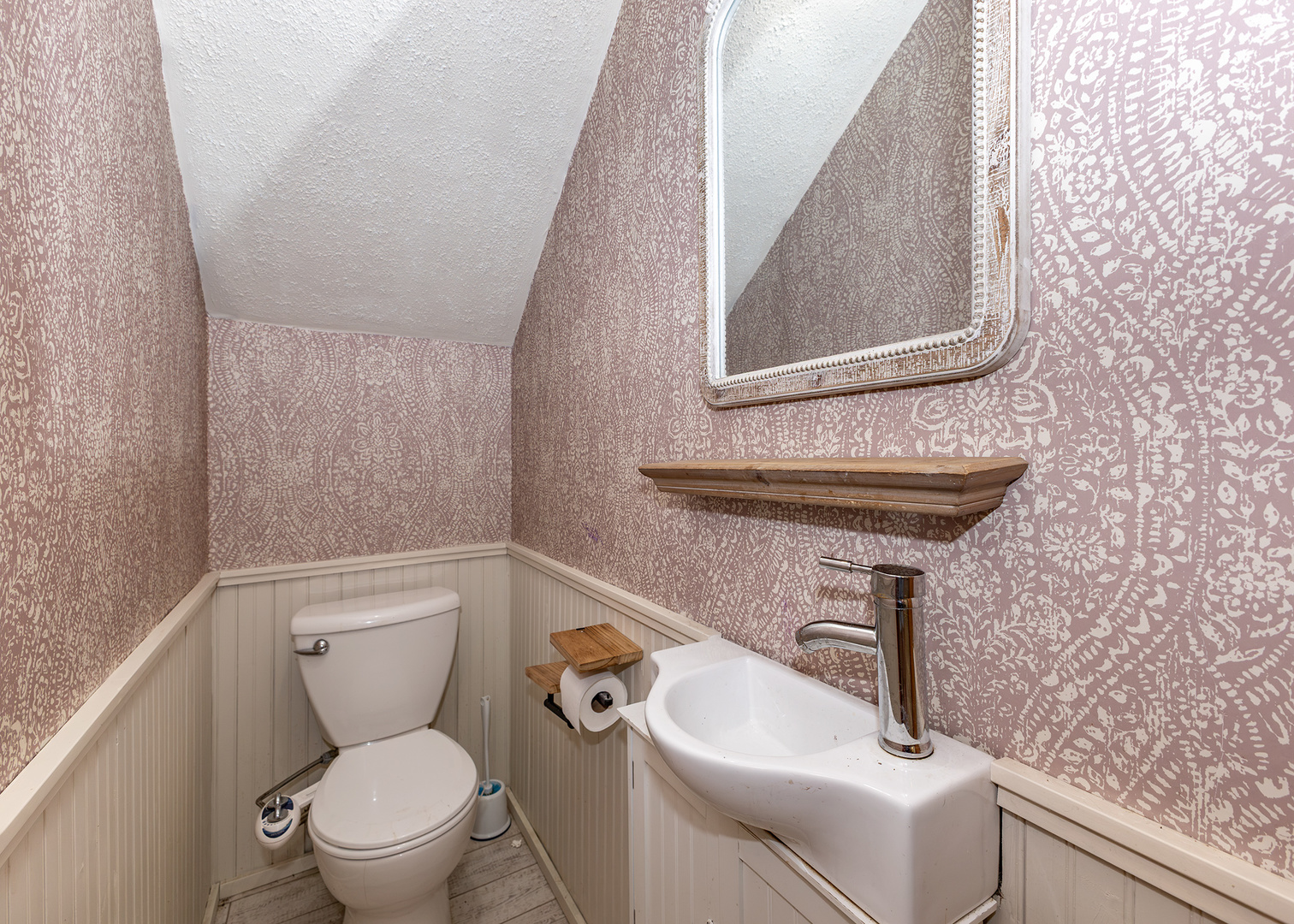 112 South State Street Atkinson, IL 61235 - Photo 10 of 24 a bathroom with a toilet sink and mirror