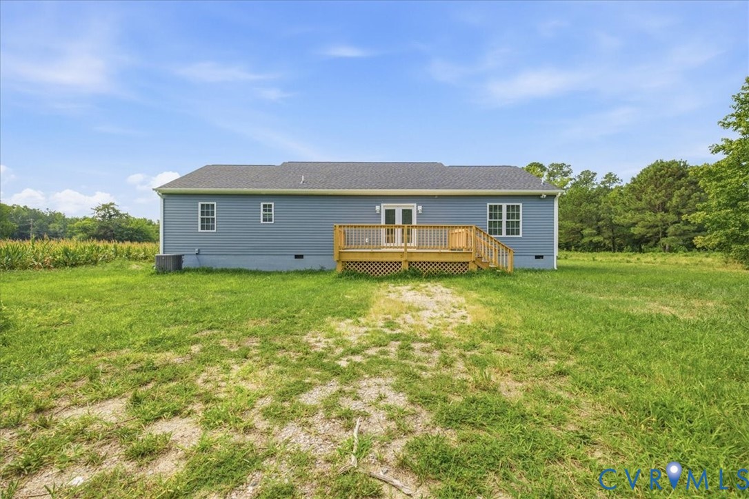 6019 Otterdam Road Waverly, VA 23890 - Photo 26 of 26 Expansive grassy yard with a wooden deck featuring