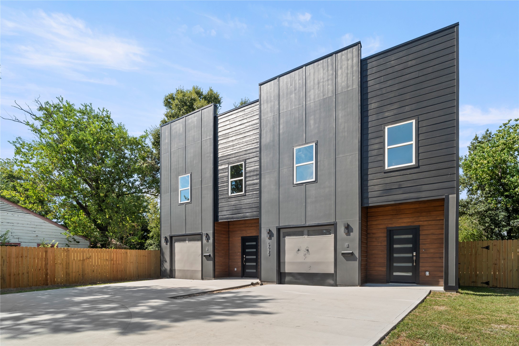 5629 Malmedy Road Houston, TX 77033 - Photo 24 of 24 Modern duplex with striking dark exterior, sleek lines, and large windows. Features spacious garage and private fenced yard, perfect for contemporary living.